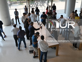 Customers browse iPhone 16 on the launch day of the iPhone 16 series at Apple BKC, in Mumbai, India, on September 20, 2024. The highly await...