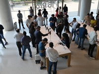 Customers browse iPhone 16 on the launch day of the iPhone 16 series at Apple BKC, in Mumbai, India, on September 20, 2024. The highly await...