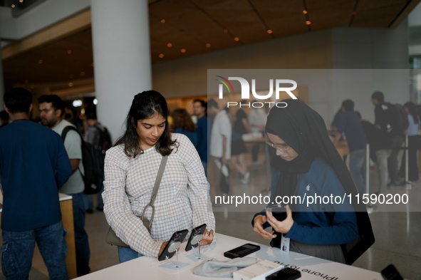 Customers browse iPhone 16 on the launch day of the iPhone 16 series at Apple BKC, in Mumbai, India, on September 20, 2024. The highly await...