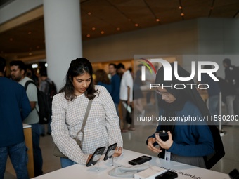 Customers browse iPhone 16 on the launch day of the iPhone 16 series at Apple BKC, in Mumbai, India, on September 20, 2024. The highly await...