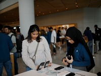 Customers browse iPhone 16 on the launch day of the iPhone 16 series at Apple BKC, in Mumbai, India, on September 20, 2024. The highly await...