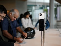 Customers browse iPhone 16 on the launch day of the iPhone 16 series at Apple BKC, in Mumbai, India, on September 20, 2024. The highly await...