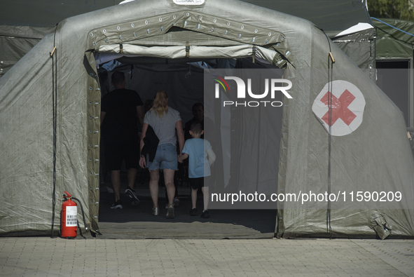 People enter the military field hospital in Nysa, Poland on September 20, 2024. On September 19, 2024 the military field hospital received f...