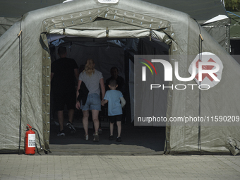 People enter the military field hospital in Nysa, Poland on September 20, 2024. On September 19, 2024 the military field hospital received f...