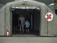 People enter the military field hospital in Nysa, Poland on September 20, 2024. On September 19, 2024 the military field hospital received f...