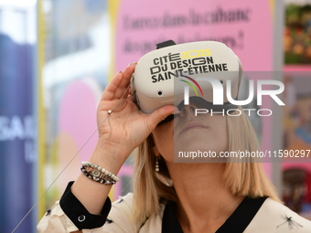 A woman with a virtual reality headset of the 2025 design in Saint Etienne, France, on September 20, 2024, during the fair. (