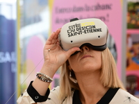 A woman with a virtual reality headset of the 2025 design in Saint Etienne, France, on September 20, 2024, during the fair. (