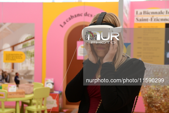 A woman with a virtual reality headset of the 2025 design in Saint Etienne, France, on September 20, 2024, during the fair. 