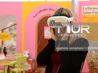 A woman with a virtual reality headset of the 2025 design in Saint Etienne, France, on September 20, 2024, during the fair. (