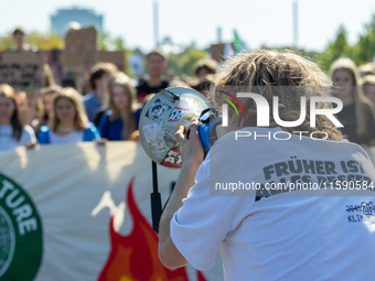 Protesters march during the global climate strike organized by Fridays for Future in Berlin, Germany, on September 20, 2024 (