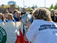 Protesters march during the global climate strike organized by Fridays for Future in Berlin, Germany, on September 20, 2024 (