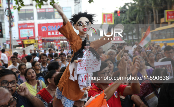 A symbolic puppet display occurs while doctors and citizens hold placards during a protest march and shout slogans, protesting against the r...