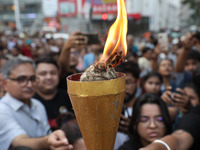 Doctors and citizens hold placards while marching with burning torches during a protest march and shout slogans, protesting against the rape...