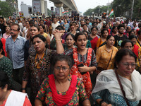 Doctors and citizens hold placards while marching with burning torches during a protest march and shout slogans, protesting against the rape...