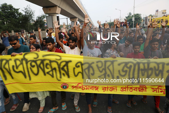 Doctors and citizens hold placards while marching with burning torches during a protest march and shout slogans, protesting against the rape...