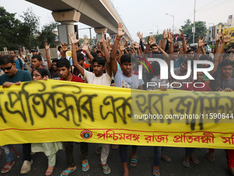 Doctors and citizens hold placards while marching with burning torches during a protest march and shout slogans, protesting against the rape...