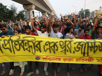 Doctors and citizens hold placards while marching with burning torches during a protest march and shout slogans, protesting against the rape...