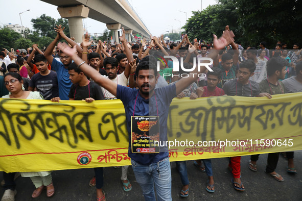 Doctors and citizens hold placards while marching with burning torches during a protest march and shout slogans, protesting against the rape...