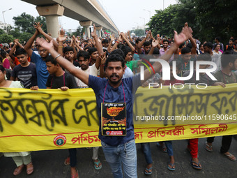 Doctors and citizens hold placards while marching with burning torches during a protest march and shout slogans, protesting against the rape...