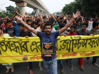 Doctors and citizens hold placards while marching with burning torches during a protest march and shout slogans, protesting against the rape...