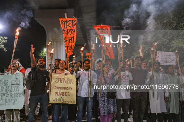 Activists and protesters hold a torch march in Dhaka, Bangladesh, on September 20, 2024. They demand the arrest and trial of those involved...