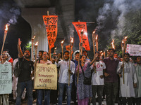 Activists and protesters hold a torch march in Dhaka, Bangladesh, on September 20, 2024. They demand the arrest and trial of those involved...