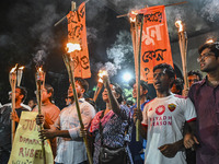 Activists and protesters hold a torch march in Dhaka, Bangladesh, on September 20, 2024. They demand the arrest and trial of those involved...