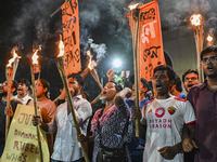 Activists and protesters hold a torch march in Dhaka, Bangladesh, on September 20, 2024. They demand the arrest and trial of those involved...