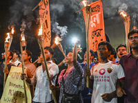 Activists and protesters hold a torch march in Dhaka, Bangladesh, on September 20, 2024. They demand the arrest and trial of those involved...