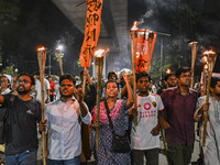 Activists and protesters hold a torch march in Dhaka, Bangladesh, on September 20, 2024. They demand the arrest and trial of those involved...