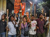 Activists and protesters hold a torch march in Dhaka, Bangladesh, on September 20, 2024. They demand the arrest and trial of those involved...