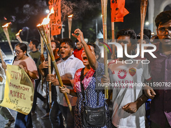 Activists and protesters hold a torch march in Dhaka, Bangladesh, on September 20, 2024. They demand the arrest and trial of those involved...