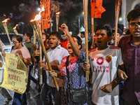 Activists and protesters hold a torch march in Dhaka, Bangladesh, on September 20, 2024. They demand the arrest and trial of those involved...