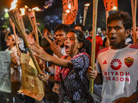 Activists and protesters hold a torch march in Dhaka, Bangladesh, on September 20, 2024. They demand the arrest and trial of those involved...