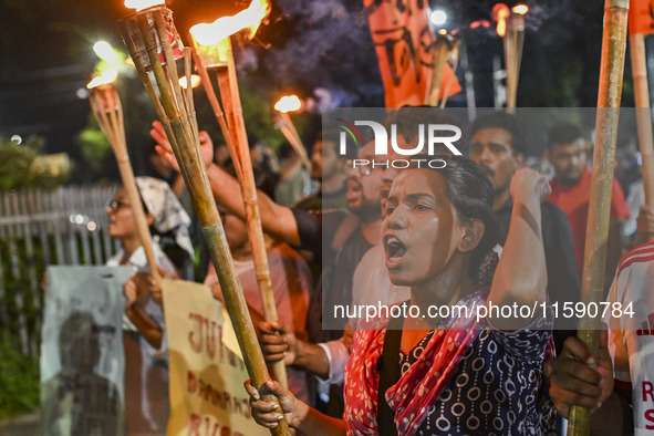 Activists and protesters hold a torch march in Dhaka, Bangladesh, on September 20, 2024. They demand the arrest and trial of those involved...