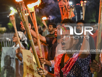 Activists and protesters hold a torch march in Dhaka, Bangladesh, on September 20, 2024. They demand the arrest and trial of those involved...