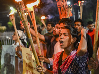 Activists and protesters hold a torch march in Dhaka, Bangladesh, on September 20, 2024. They demand the arrest and trial of those involved...