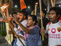 Activists and protesters hold a torch march in Dhaka, Bangladesh, on September 20, 2024. They demand the arrest and trial of those involved...