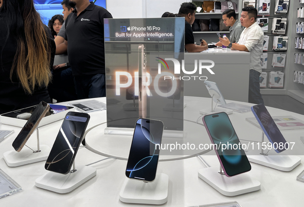 People arrive at an Apple premium reseller store as the iPhone 16 series starts selling in Guwahati, India, on September 20, 2024. 