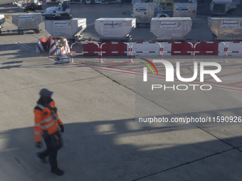 An airport worker stands on land at Orly Airport in Paris, France, on September 15, 2024. Airports Council International (ACI) World release...