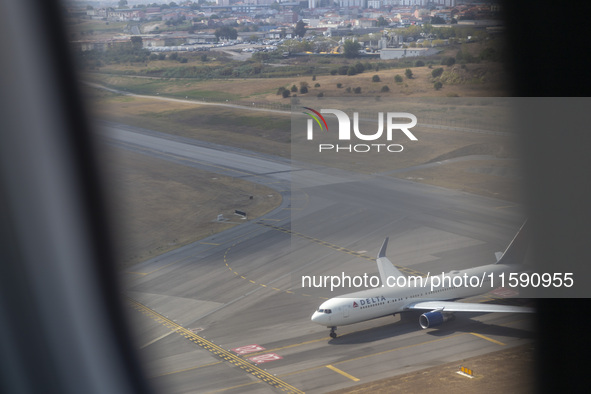 An airplane is seen from another airplane at Lisbon airport in Lisbon, Portugal, on September 18, 2024. Airports Council International (ACI)...