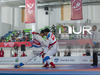 Jiu-jitsu athlete from North Sumatra, Raihan Syauqi (blue), competes against Frederikus Karubun, an athlete from the Central Papua contingen...