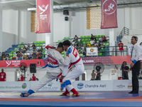 Jiu-jitsu athlete from North Sumatra, Raihan Syauqi (blue), competes against Frederikus Karubun, an athlete from the Central Papua contingen...