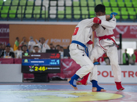 Adi Tiyawan, an East Kalimantan Jiu-jitsu athlete (Red), and Handoko Wahyu (Blue) from the West Java contingent fight in the Men's -62 KG Fi...