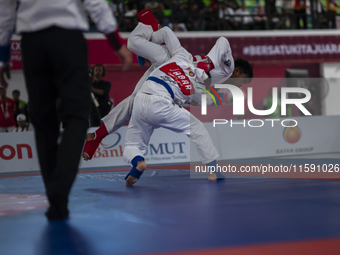 Adi Tiyawan, an East Kalimantan Jiu-jitsu athlete (Red), and Handoko Wahyu (Blue) from the West Java contingent compete in the Men's -62 KG...