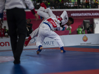 Adi Tiyawan, an East Kalimantan Jiu-jitsu athlete (Red), and Handoko Wahyu (Blue) from the West Java contingent compete in the Men's -62 KG...