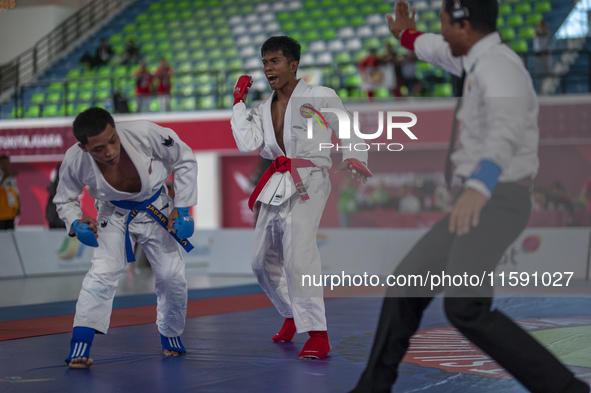 Adi Tiyawan, an East Kalimantan Jiu-jitsu athlete (Red), and Handoko Wahyu (Blue) from the West Java contingent compete in the Men's -62 KG...