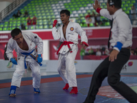 Adi Tiyawan, an East Kalimantan Jiu-jitsu athlete (Red), and Handoko Wahyu (Blue) from the West Java contingent compete in the Men's -62 KG...