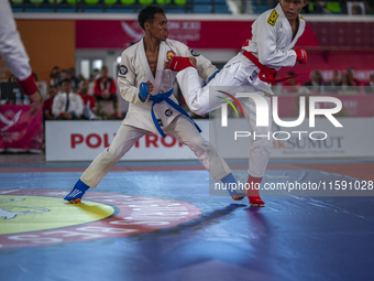 Aceh Province Ju-Jitsu athlete Aldo Afriansyah competes against Central Java Ju-Jitsu athlete Yulianto (Blue) in the men's fighting system -...