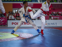 Aceh Province Ju-Jitsu athlete Aldo Afriansyah competes against Central Java Ju-Jitsu athlete Yulianto (Blue) in the men's fighting system -...